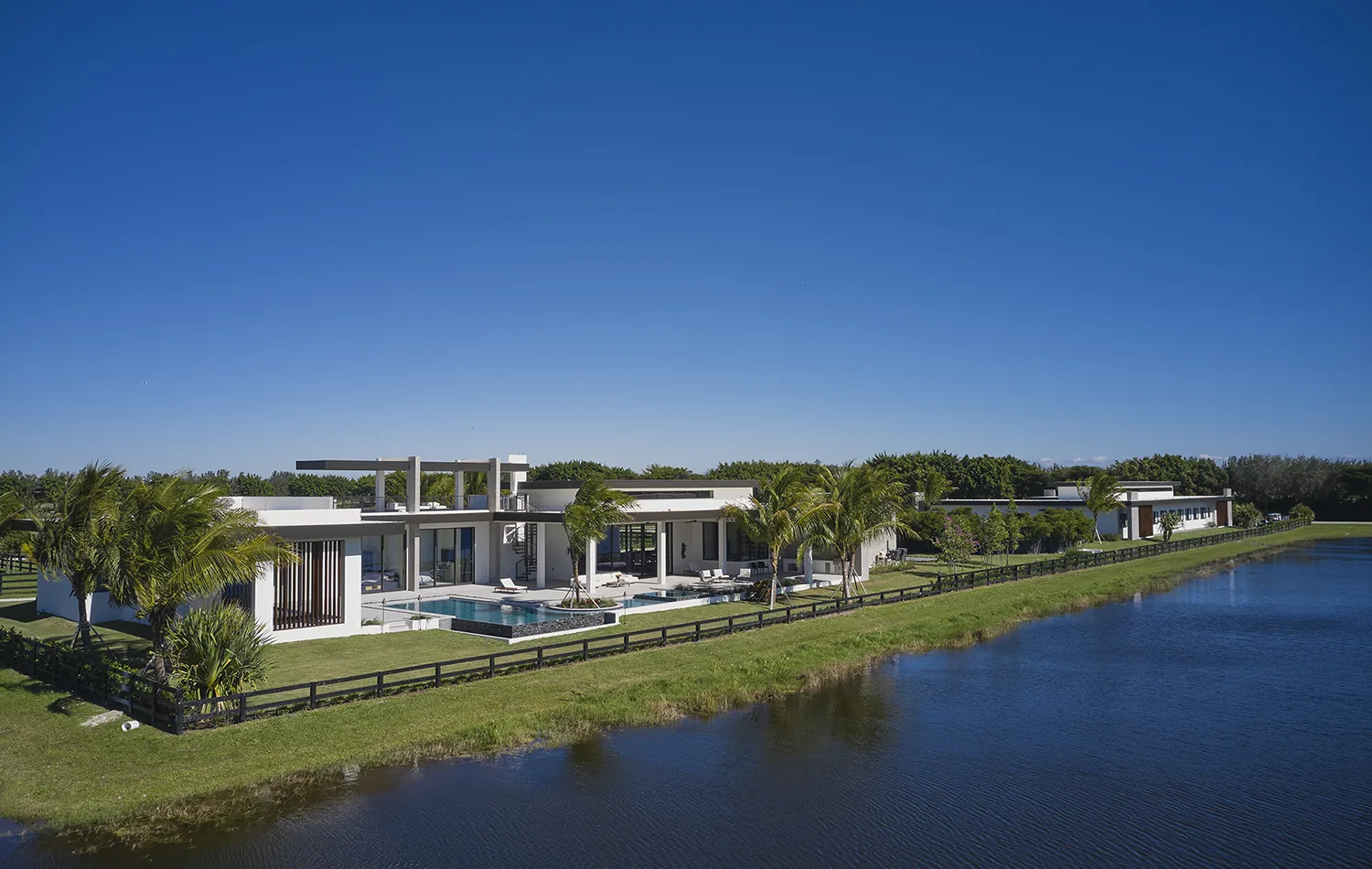 Aerial view of the residence and lake at Lasso Way Estate